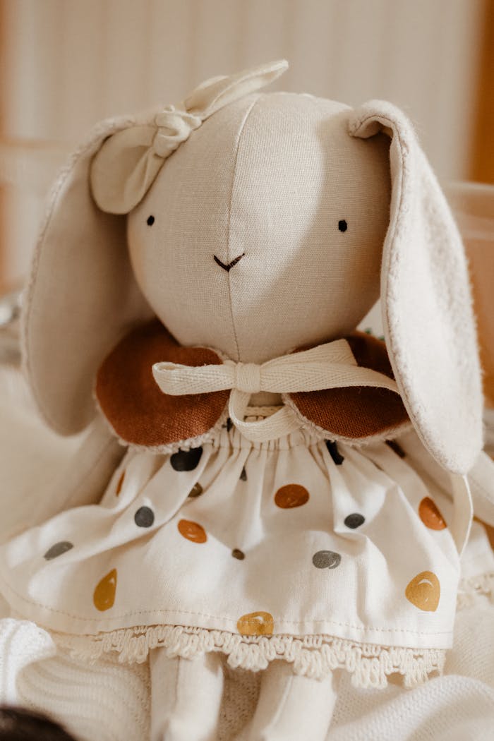 Charming handmade bunny toy with embroidered features, perfect for kids and nursery decor.